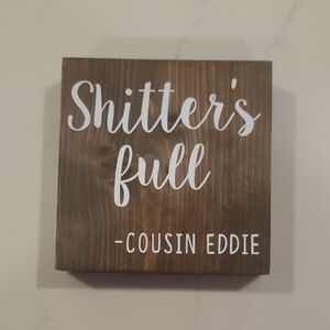 Brown Wooden Sign with White Text